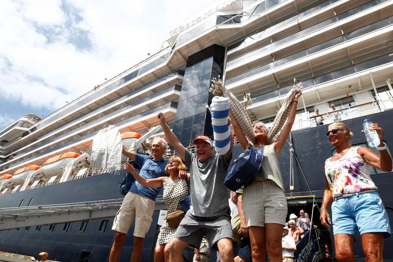 Passengers react after they disembark from the MS Westerdam at the port of Sihanoukville, Cambodia. AP Photo