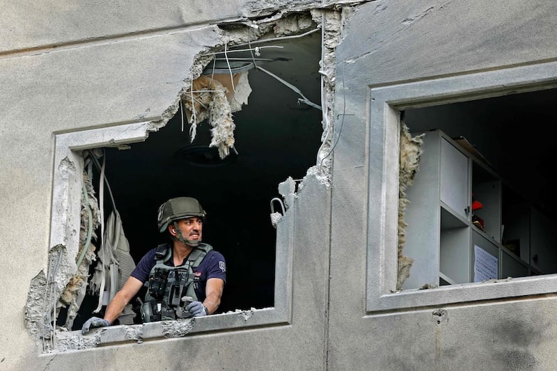 An Israeli sapper checks a damaged apartment in the southern Israeli city of Ashkelon, after rockets were fired by the Hamas movement from the Gaza Strip towards Israel overnight. AFP