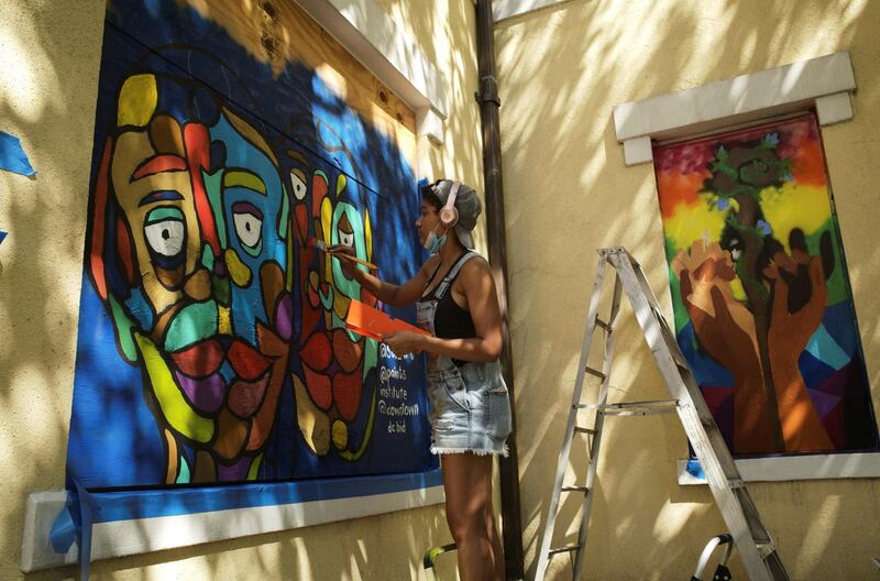 Senia Cade, curated by Paints Institute, paints a mural on the boarded-up windows of St. John's Church as a work of art activism for racial justice at Black Lives Matter Plaza in Washington, U.S. REUTERS