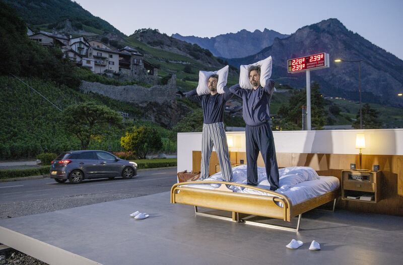 Swiss artists Frank and Patrik Riklin pose on the bed in the anti-idyllic suite of the Null-Stern-Hotel (Zero-Star-Hotel), which offers guests a choice of four open-air rooms in Saillon, Switzerland. Reuters