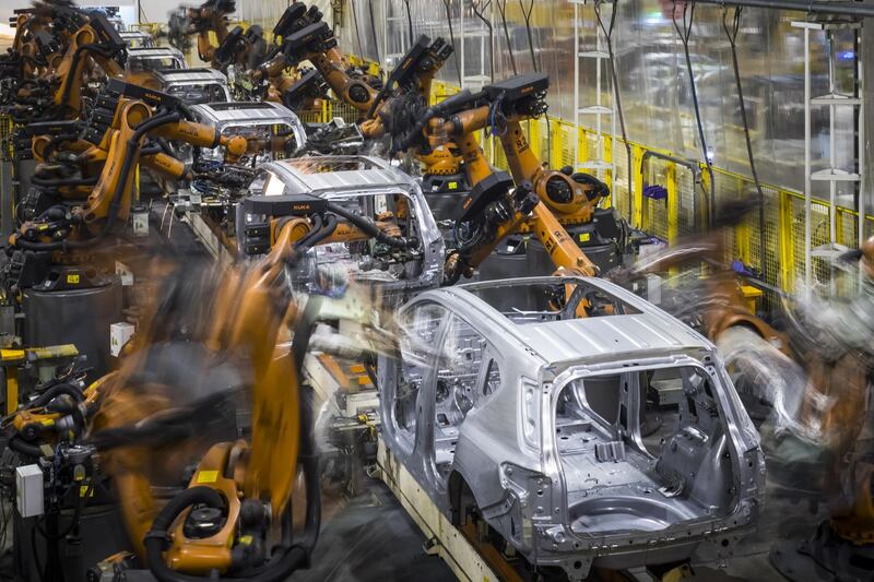 Robotic arms, manufactured by Kuka AG, work on the chassis of Trumpchi brand vehicles on a production line at the Guangzhou Automobile Group Co. Ltd. (GAC) plant in Guangzhou, China, on Thursday, Nov. 2, 2017. Trumpchi, the Chinese auto brand established in 2010 and now preparing for U.S. sales, has become a topic of debate as owner GAC considers whether American consumers would love or hate the marque with a name similar to that of the current U.S. president. Photographer: Qilai Shen/Bloomberg