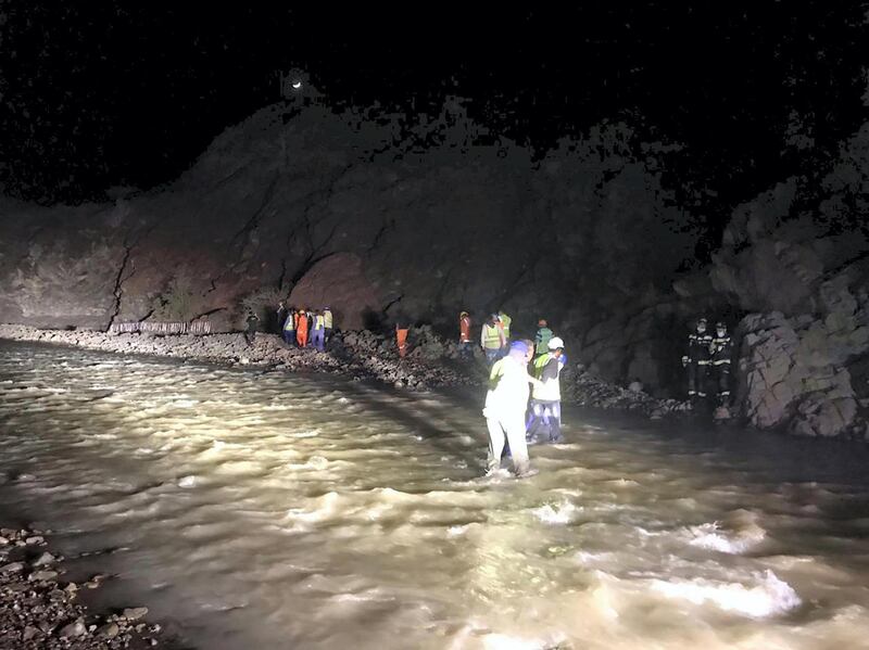 The 20 passengers are led to safety on foot in the Hatta valley on Tuesday night. Courtesy: Dubai Police