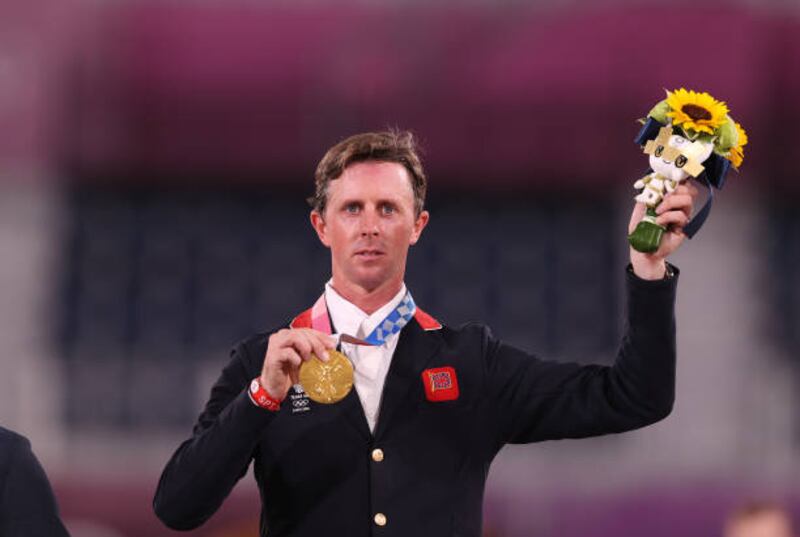 Ben Maher of Great Britain poses on the podium with his gold medal after winning the Jumping Individual Final.