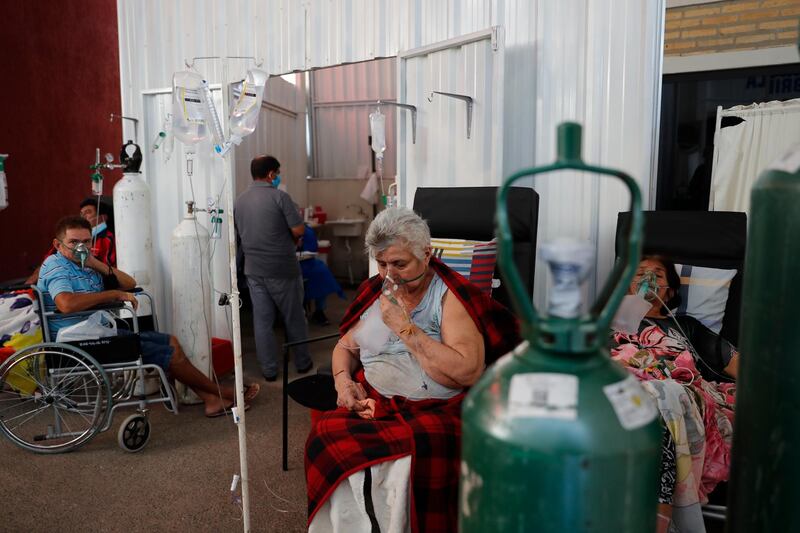 Patients breathe from oxygen tanks as they wait for a bed to open in the Covid-19 treatment area of the hospital in Villa Elisa, Paraguay. AP Photo