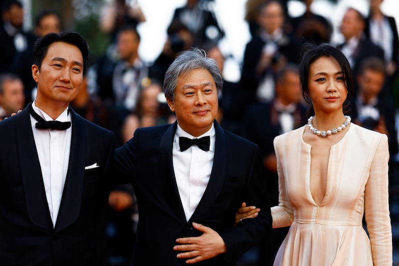 Director Park Chan-wook and cast members Tang Wei and Park Hae-il after the Cannes screening of Decision to Leave (Haeojil Gyeolsim). Reuters