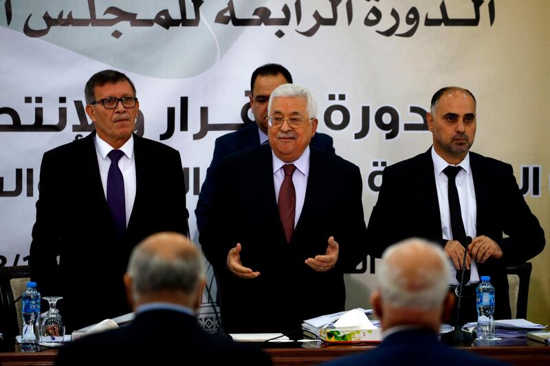 Palestinian Authority President Mahmud Abbas (C) recites the Fatiha, or the prayer of the dead, during a meeting with the Revolutionary Council of the ruling Fatah party in the West Bank city of Ramallah on October 12, 2018. / AFP / ABBAS MOMANI
