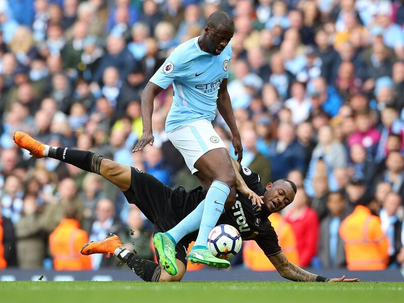 epa06685872 Manchester City's Yaya Toure (up) in action against Swansea's Andre Ayew (bottom) during the English Premier League soccer match between Manchester City and Swansea City in Manchester, Britain, 22 April 2018.  EPA/NIGEL RODDIS EDITORIAL USE ONLY. No use with unauthorised audio, video, data, fixture lists, club/league logos 'live' services. Online in-match use limited to 75 images, no video emulation. No use in betting, games or single club/league/player publications.