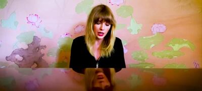 Taylor Swift perfromed in front of lotus flower-print wallpaper. YouTube 