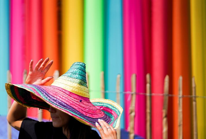 A reveller wears a rainbow coloured hat at Glastonbury Festival  in Somerset, Britain. Reuters