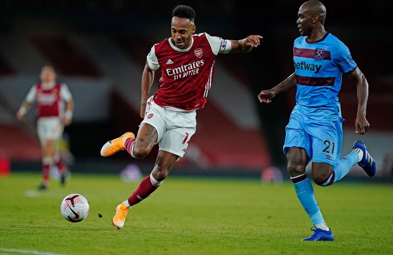 Arsenal's Pierre-Emerick Aubameyang, left, and West Ham's Angelo Ogbonna battle for the ball during the English Premier League soccer match between Arsenal and West Ham at the Emirates Stadium in London, England, Saturday, Sept. 19, 2020. (Will Oliver/Pool via AP)