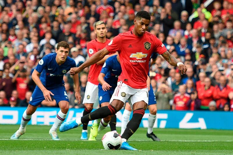 Manchester United's English striker Marcus Rashford (C) shoots to score from the penalty spot for the opening goal during the English Premier League football match between Manchester United and Chelsea at Old Trafford in Manchester, north west England, on August 11, 2019. RESTRICTED TO EDITORIAL USE. No use with unauthorized audio, video, data, fixture lists, club/league logos or 'live' services. Online in-match use limited to 120 images. An additional 40 images may be used in extra time. No video emulation. Social media in-match use limited to 120 images. An additional 40 images may be used in extra time. No use in betting publications, games or single club/league/player publications.
 / AFP / Oli SCARFF                           / RESTRICTED TO EDITORIAL USE. No use with unauthorized audio, video, data, fixture lists, club/league logos or 'live' services. Online in-match use limited to 120 images. An additional 40 images may be used in extra time. No video emulation. Social media in-match use limited to 120 images. An additional 40 images may be used in extra time. No use in betting publications, games or single club/league/player publications.
