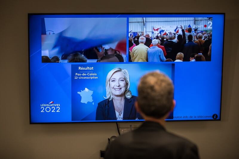 A journalist watches Marine Le Pen giving a speech on TV after the results of the second round of French legislative elections. The polls are held to elect the 577 members for the French parliament. EPA