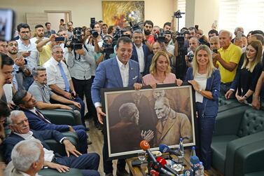 Ekrem Imamoglu, the new Mayor of Istanbul from the CHP poses with a picture of modern Turkey founder Mustafa Kemal Ataturk. AFP