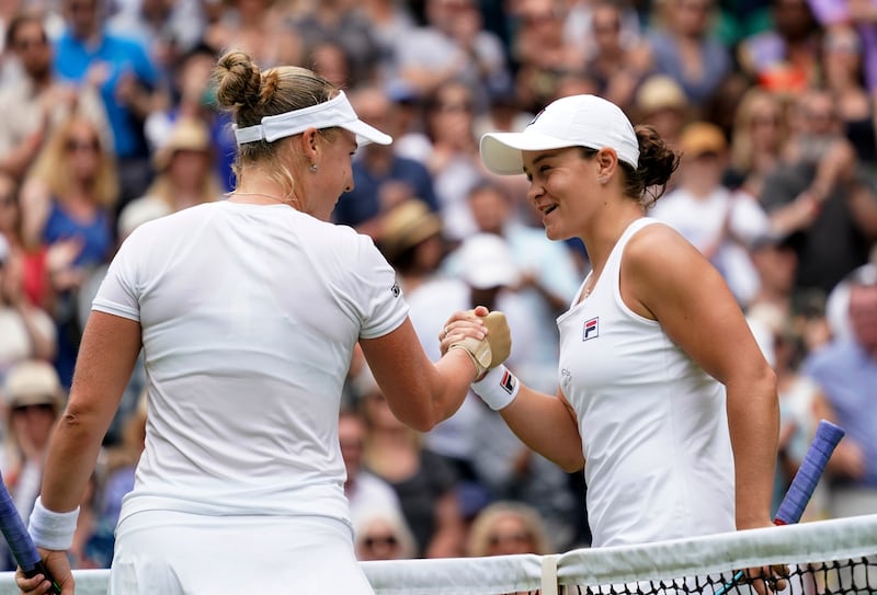 Australia's Ashleigh Barty shakes hands with Russia's Anna Blinkova, left, after winning the women's singles second round match at Wimbledon. AP