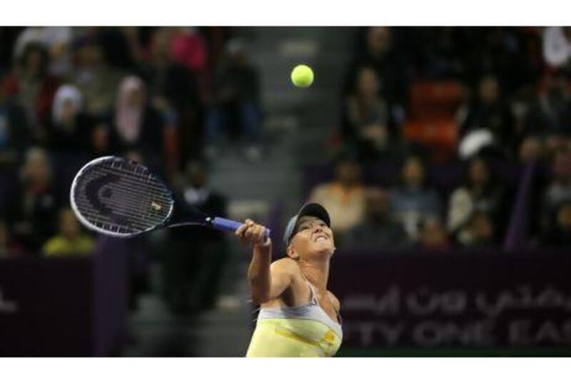 Maria Sharapova of Russia returns the ball to Caroline Garcia of France during their match on the second day of the WTA Qatar Open in the capital Doha, on February 12, 2013. AFP PHOTO / AL-WATAN DOHA / KARIM JAAFAR == QATAR OUT ==
 *** Local Caption *** 474427-01-08.jpg