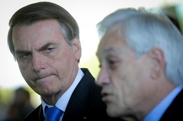 Jair Bolsonaro, Brazil's president, listens as Sebastian Pinera, Chile's president, speaks during a joint press conference at the Alvorada Palace in Brasilia, Brazil, on Wednesday, August 28, 2019. Andre Coelho/Bloomberg