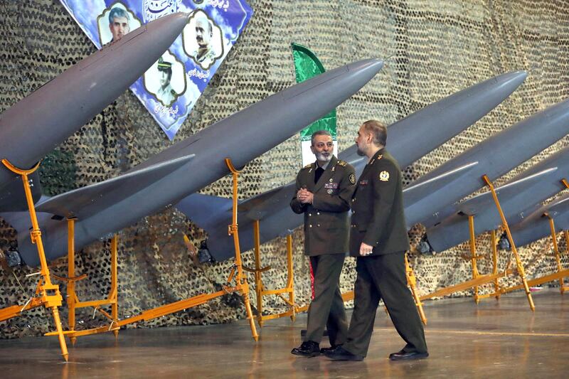 Senior Iranian regime officials walk near drones inducted into Iran's army, in Tehran, last month. Reuters