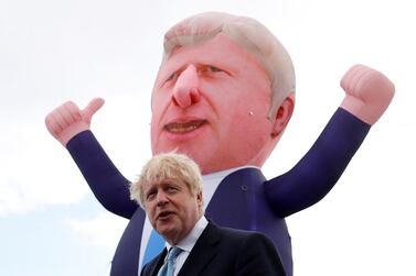 Britain's Prime Minister Boris Johnson speaks, in front of an inflatable figure of himself, in Hartlepool after his party's election victory there. Reuters  