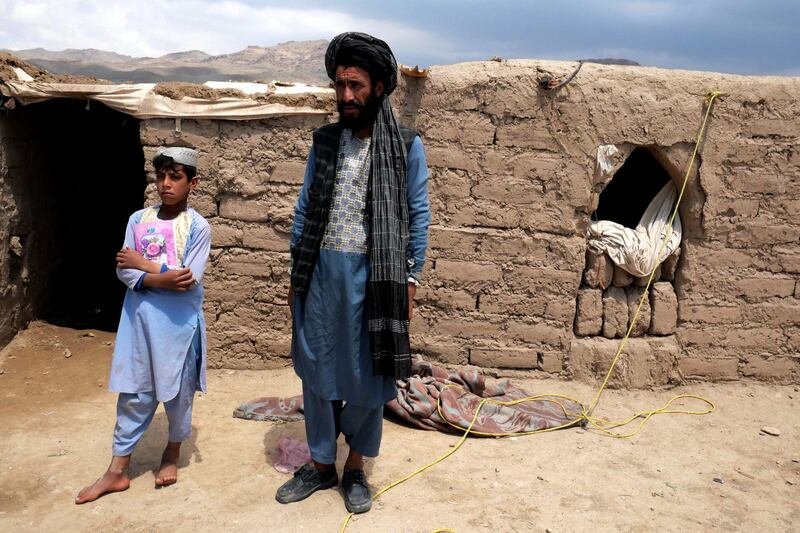 Pictured: Khan Mohammad, 40, with one of his sons, standing outside of the mud hut they now call home, having fled their village due to drought. The family now lives in an unofficial IDP camp in Herat.
Photo by Charlie Faulkner
May 2021