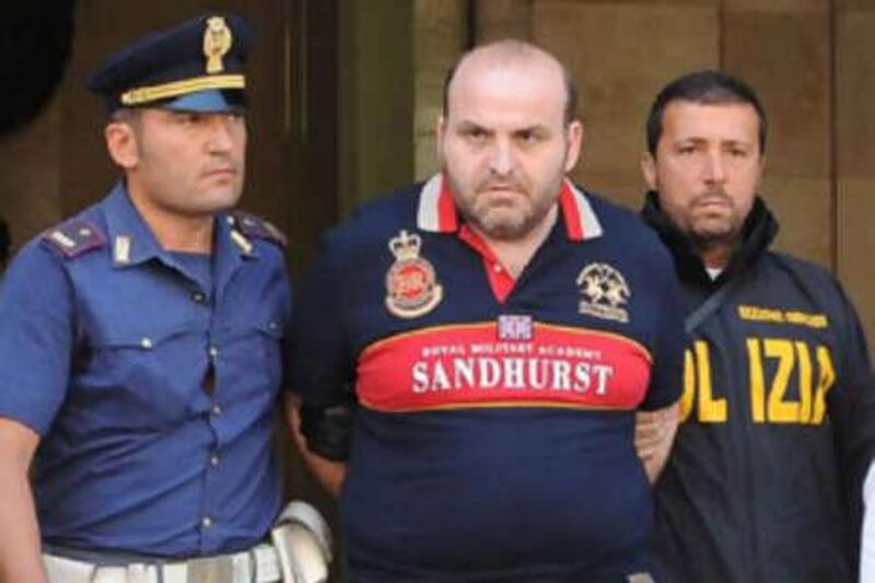 Italian Elio Amato (C) pictured during his arrest by Italian police on in Naples. Amato was on the country's list of 100 most dangerous wanted criminals.