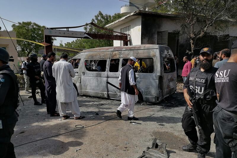 Police inspect the site of a deadly blast near the China Institute at the Karachi University in Pakistan. AFP