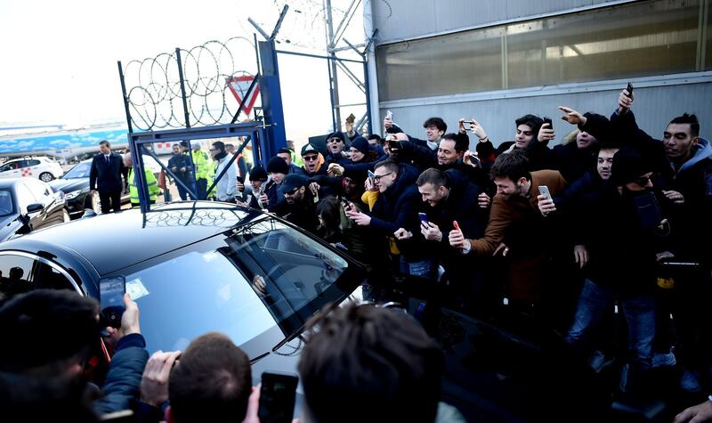 Ibrahimovic leaves in a car surrounded by supporters. AFP