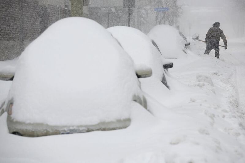 A man shovels snow during a winter storm in Canada. Reuters