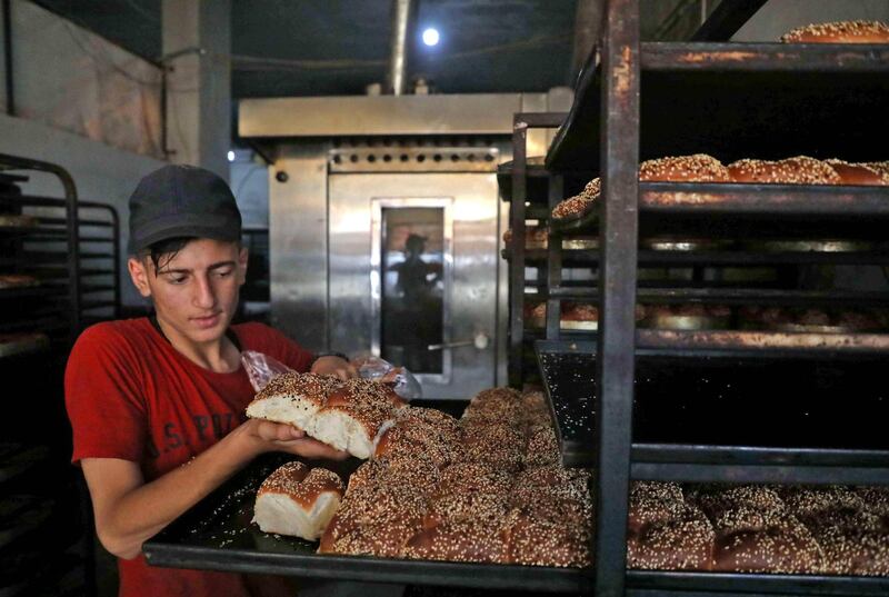 Traditional sweets being prepared at a bakery run by displaced Syrians in the town of Dana, east of the Turkish-Syrian border in the northwestern Idlib province. Aaref Watad / AFP