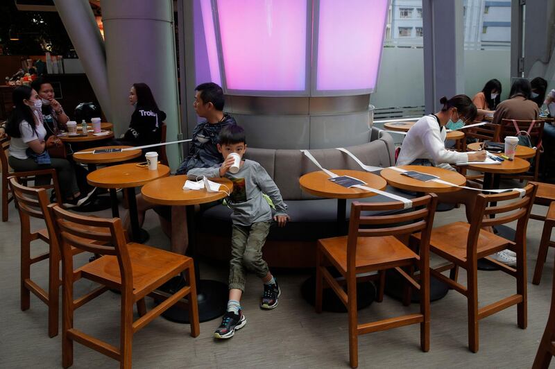 Tables and chairs are taped for the social distancing law enforcement to help curb the spread of the coronavirus at a Starbucks coffee shop in Hong Kong.  AP Photo