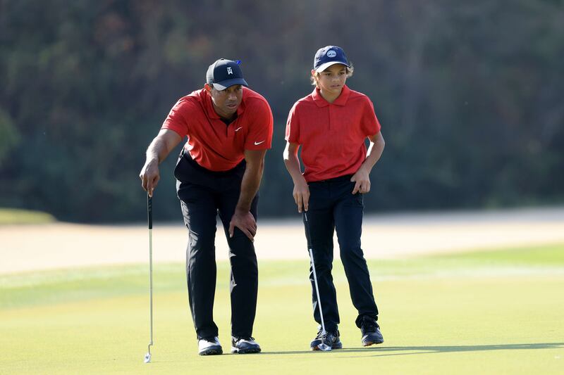 Tiger Woods and Charlie size up a shot on the 15th hole. AFP