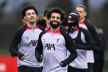 Liverpool's Curtis Jones and Mohamed Salah during a training session ahead of Tuesday's Champions League soccer match against Real Madrid, at the AXA Training Centre, Liverpool, England, Monday Feb.  20, 2023.  (Martin Rickett / PA via AP)