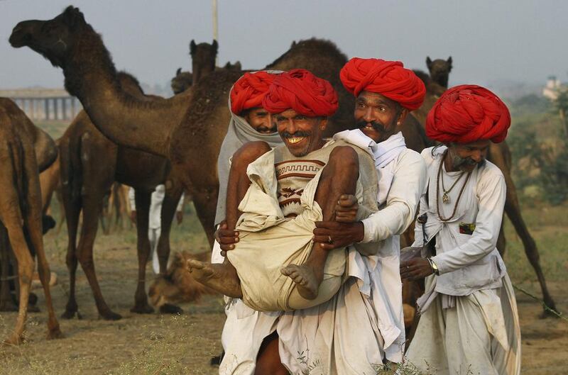 Indian camel herders play around during the annual cattle fair in Pushkar, Rajasthan state, India. Deepak Sharma / AP