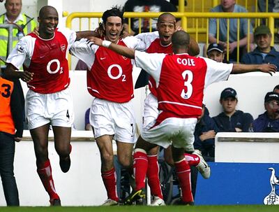 Arsenal's French midfielder Robert Pires (2ndL) celebrates his goal against Tottenham with teammates captain Patrick Vieira (L), forward Thierry Henry (2ndR) and Ashley Cole (back to the camera) during their Premier League football clash at White Hart Lane in north London, 25 April 2004.  AFP PHOTO / ODD ANDERSEN     - - No telcos,website use to description of license with FAPL on, www.faplweb.com - - / AFP PHOTO / ODD ANDERSEN