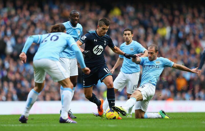 MANCHESTER, ENGLAND - NOVEMBER 24: Erik Lamela of Tottenham Hotspur is tackled by Pablo Zabaleta of Manchester City during the Barclays Premier League match between Manchester City and Tottenham Hotspur at Etihad Stadium on November 24, 2013 in Manchester, England.  (Photo by Alex Livesey/Getty Images)