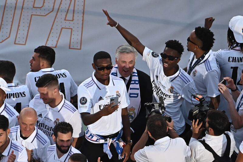 Real Madrid manager Carlo Ancelotti and his players enjoy the open top bus parade. EPA