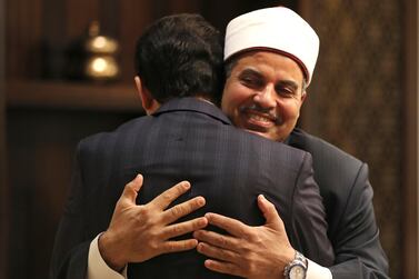 Prof. Mohamed Hussein El-Mahrassawy, President of Al-Azhar University, right, hugs Judge Mohamed Mahmoud Abdel Salam, former advisor to the Grand Imam of Al-Azhar, at a roundtable discussion in Abu Dhabi, United Arab Emirates, Monday, Feb. 3, 2020. Interfaith leaders gathered on Monday in Abu Dhabi to mark one year since Pope Francis' historic trip to the Arabian Peninsula. Abu Dhabi hosted the meeting on Monday to showcase its continued efforts in promoting interfaith dialogue as it prepares to break ground this year on a compound that will house a mosque, church and synagogue side by side. (AP Photo/Kamran Jebreili)