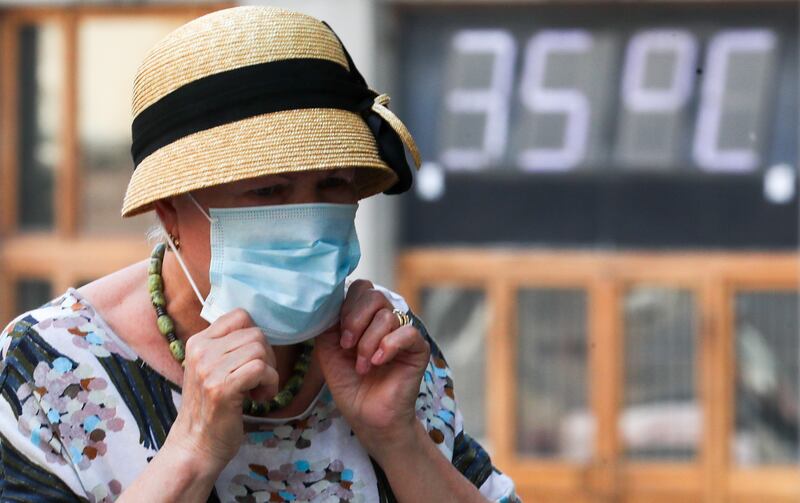 A woman wears a face mask during a heatwave in central Moscow. Getty Images