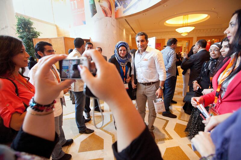 Dubai, United Arab Emirates, May 09, 2012 -  Bassem Youssef (white shirt) pose for a picture with a fan after having participated in the YouTube Channels session during the Arab Media Forum at Grand Hyatt Hotel.    ( Jaime Puebla / The National Newspaper )