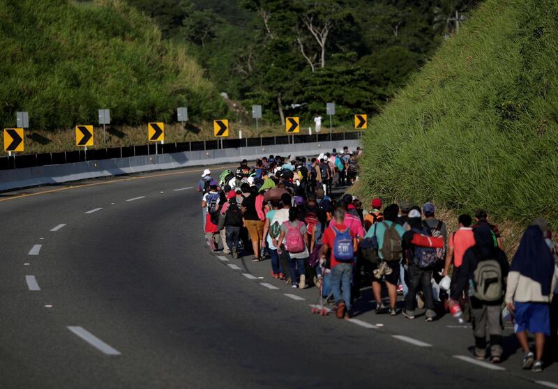 Migrants walk by the road that links Metapa with Tapachula, Mexico. Reuters