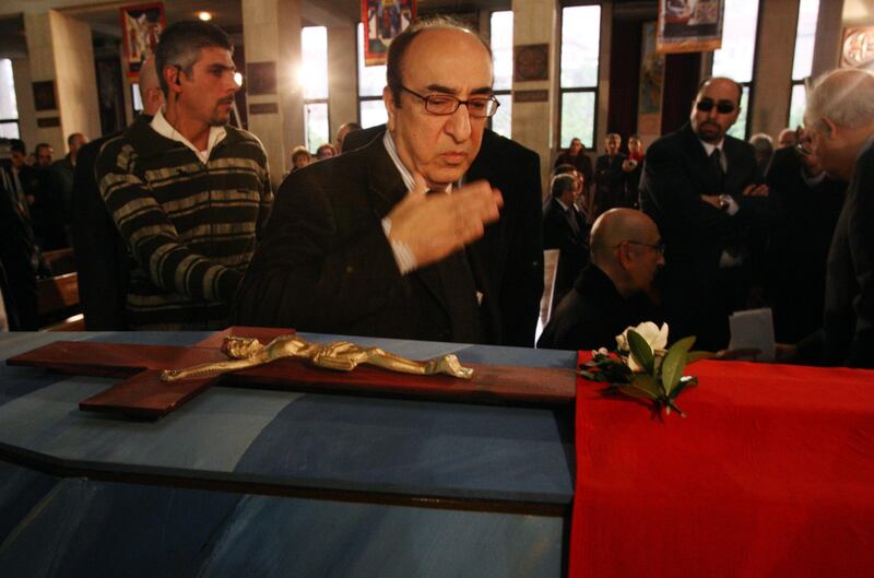 Elias Rahbani bids farewell to his late brother, composer Mansour Rahbani, as he walks past his coffin during his funeral at a church in Antelias, a northern suburb of Beirut in 2009. AFP