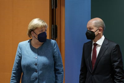 Mr Scholz with Chancellor Angela Merkel at a cabinet meeting in Berlin on Wednesday. Getty 