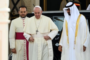 Pope Francis is welcomed to the UAE by Abu Dhabi's Crown Prince Sheikh Mohamed bin Zayed. Far left is Monsignor Yoannis Lahzi Gaid, who often assists with translations for the pontiff. AFP