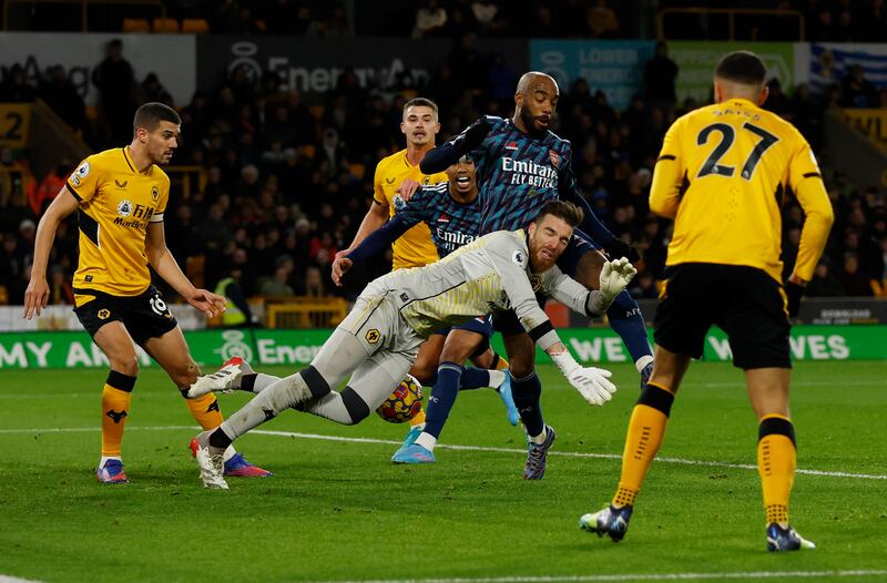 Arsenal's Alexandre Lacazette challenges Wolves goalkeeper Jose Sa ahead of Gabriel's goal. Reuters