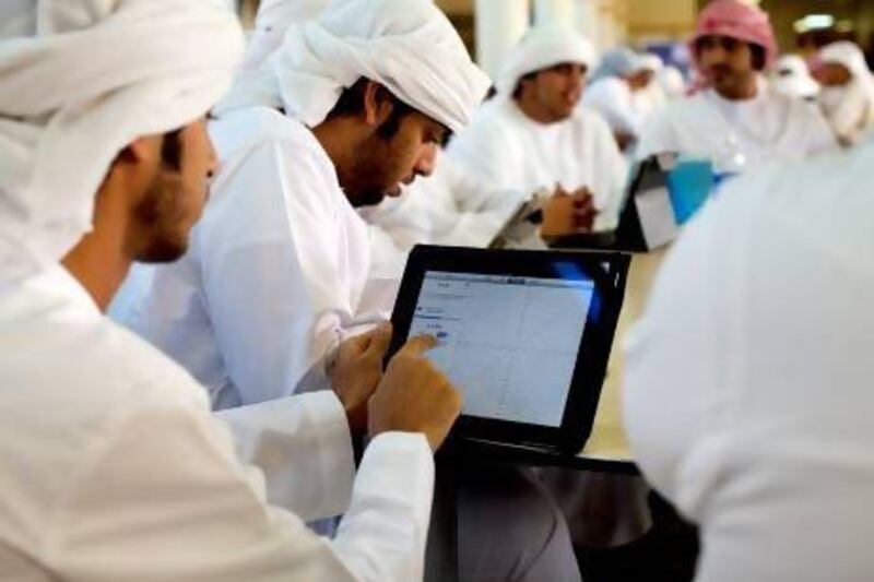 Uncluttered desks: students at Abu Dhabi Men's College use their iPads in class as the education authority prepares them to take on the cyberworld. Christopher Pike / The National