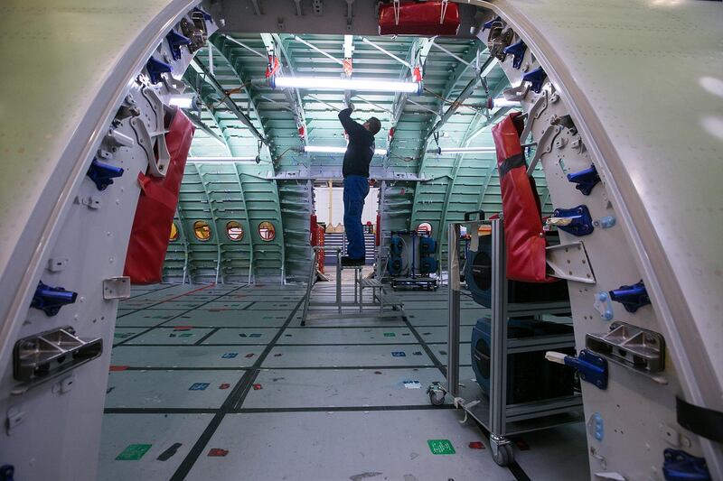 An employee inspects the interior of the upper passenger deck of an Airbus A380 in Hamburg. Bloomberg