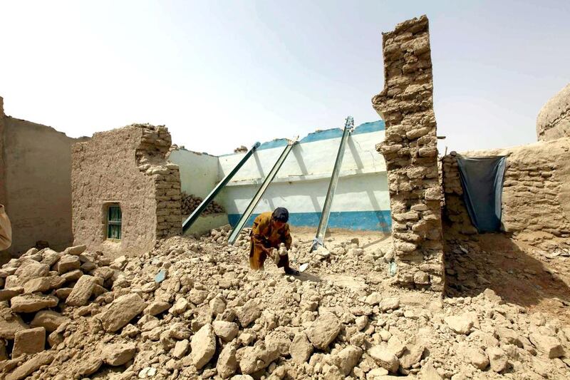 A boy roots the rubble of his home, in Awaran district of Pakistan's Baluchistan, where a second earthquake of 6.8 magnitude struck on Saturday after a 7.7-magnitude earthquake on September 24 in which hundreds of people were killed. Shahzaib Akber / EPA