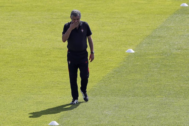 Portugal coach Fernando Santos walks on the pitch during a training session, in preparation of the Euro 2016 final soccer match between France and Portugal, at Marcoussis, south of Paris, France, Friday, July 8, 2016. (AP Photo/Francois Mori)