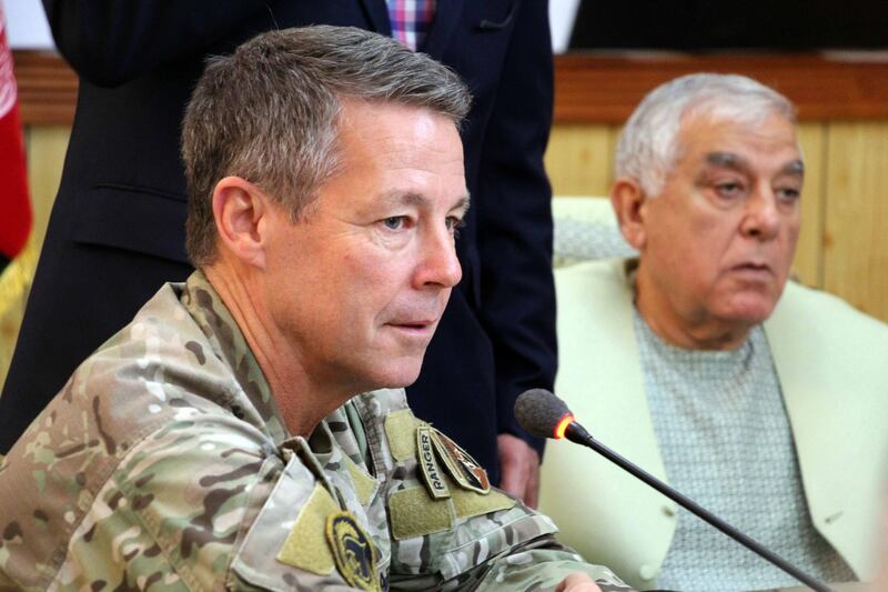 epa07102806 Austin Scott Miller (L), the US commander of Nato's Resolute Support Mission in the country, attends a meeting in which a Taliban militants opened fire and killed General Abdul Razzaq Dawood, an Afghan Police commander and Provincial Intelligence Chief as US General Miller escaped unhurt, in Kandahar, Afghanistan, 18 October 2018. At least two Americans were also injured in the shooting. Since the end of NATO's combat mission in Jan 2015, the government in Kabul has been losing territory to the insurgents and the Special Inspector-General for Afghanistan Reconstruction of the US Congress said that the Afghan government now controls only 56 percent of its territory.  EPA/MUHAMMAD SADIQ