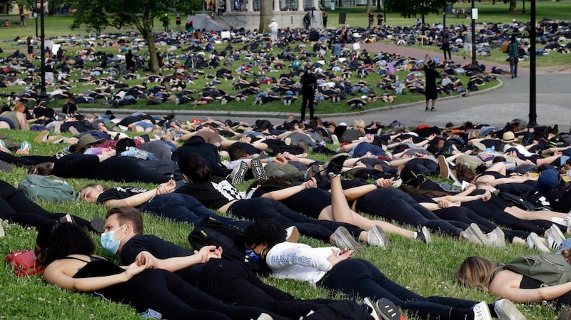 Hundreds of demonstrators lie face down depicting George Floyd during his detention by police during a protest against police brutality, on Boston Common.  AP Photo