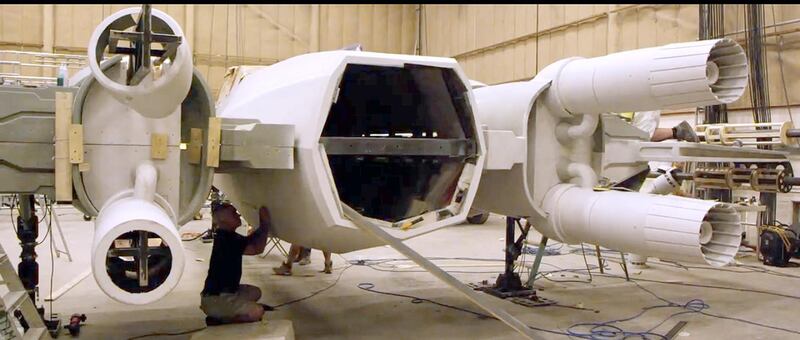 Handouts stills from a 4-minute clip from Star Wars: The Force Awakens that J.J. Abrams showed at Comic Con San Diego that highlight the filming in Abu Dhabi last year. Received July 2015. CAPTION 5: Meanwhile, back at the movie's Pinewood HQ, prop builders work on building an X-Wing. Abrams has been keen to use real props and sets in the new movie, putting the unpopular green screen techniques of the prequel trilogy to rest and returning to the feel of the original movies.
CREDIT: Courtesy Lucasfilm *** Local Caption ***  al3jl-Star Wars-5-WEB.jpg